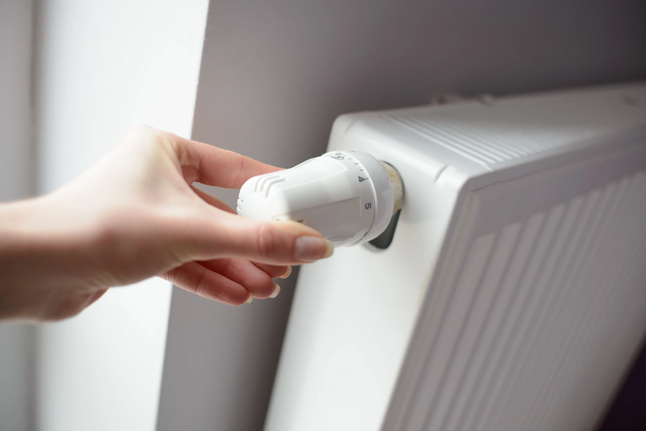 Hand adjusting a radiator thermostatic valve after boiler upgrade